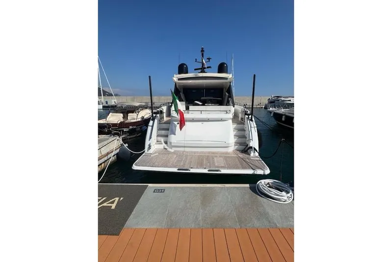  Yacht Photos Pics 2014 Princess V 72 yacht docked, rear view with Italian flag, sunny day.