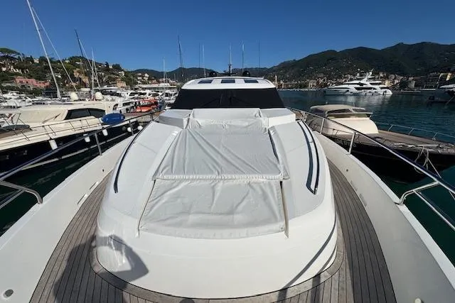  Yacht Photos Pics 2014 Princess V 72 yacht docked in a scenic marina with surrounding hills.