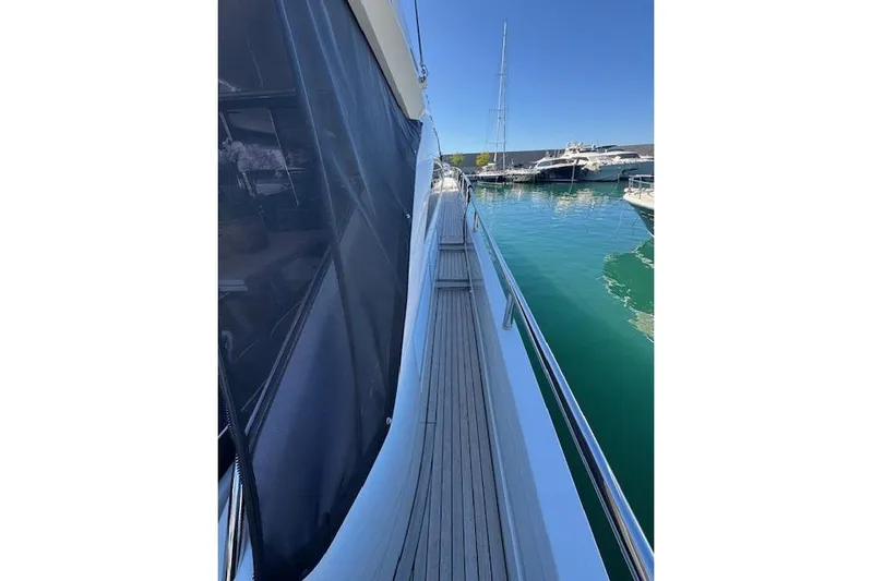  Yacht Photos Pics Side view of 2014 Princess V 72 yacht docked in a marina.