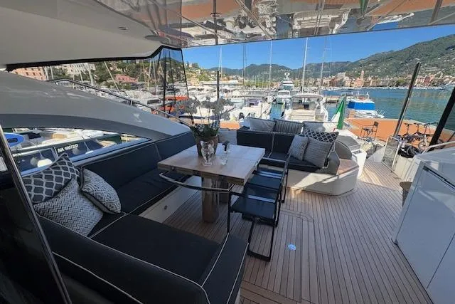  Yacht Photos Pics Luxurious 2014 Princess V 72 yacht deck with elegant seating and scenic marina view.