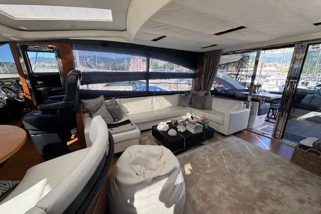  Yacht Photos Pics Luxurious interior of 2014 Princess V 72 yacht with white seating and panoramic windows.