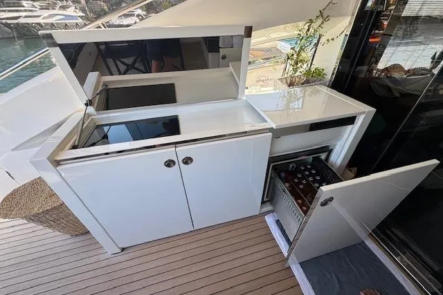  Yacht Photos Pics Luxurious 2014 Princess V 72 yacht kitchenette with sleek white cabinets and mini fridge.