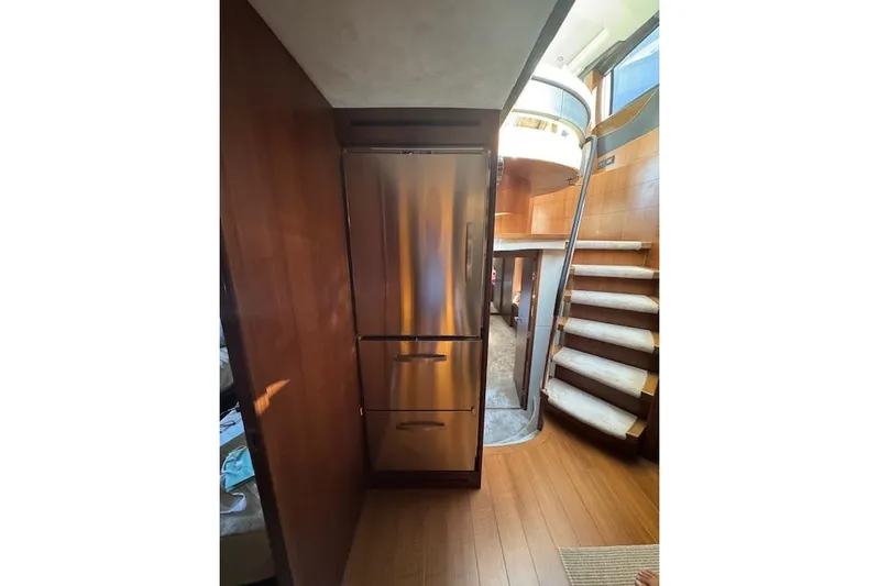  Yacht Photos Pics Interior of 2014 Princess V 72 yacht with stainless steel fridge and curved staircase.