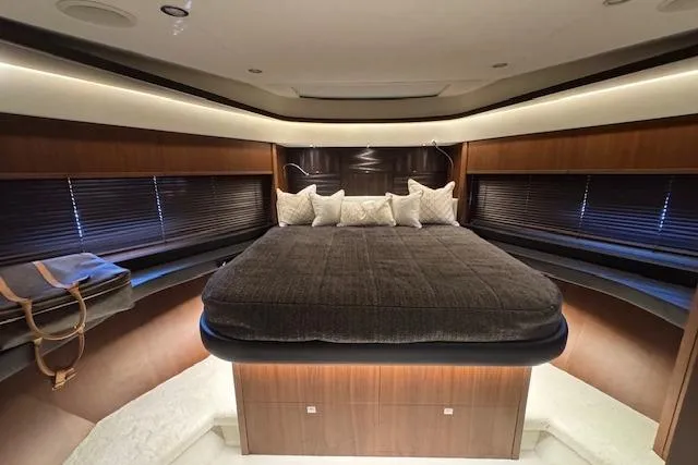  Yacht Photos Pics Luxurious bedroom interior of 2014 Princess V 72 yacht with elegant wood finishes.