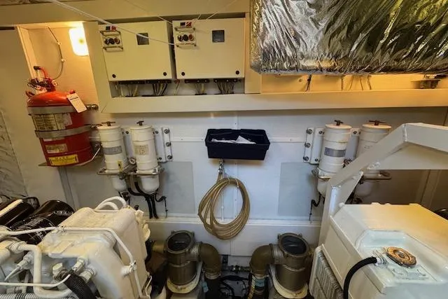 Yacht Photos Pics Engine room of 2014 Princess V 72 yacht with fire extinguisher and control panels.