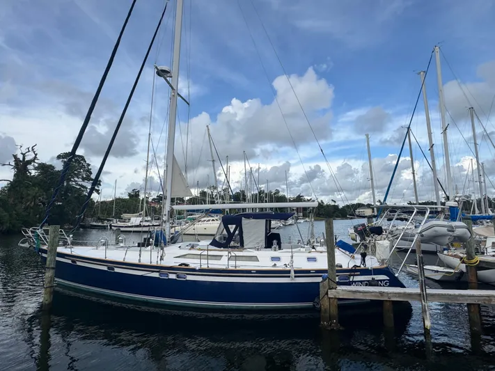 Windsong Yacht Photos Pics 1989 Taswell 49 sailboat docked at marina under cloudy sky.