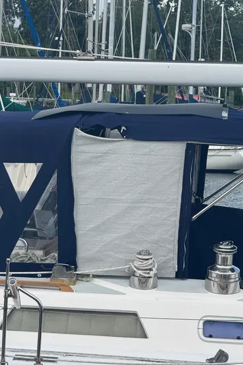 Windsong Yacht Photos Pics 1989 Taswell 49 sailboat with blue canvas cover and winches in a marina setting.