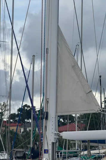 Windsong Yacht Photos Pics Sailboat mast and rigging of 1989 Taswell 49 under cloudy sky.