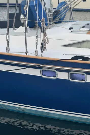 Windsong Yacht Photos Pics 1989 Taswell 49 sailboat with blue hull and deck details, docked in a marina.