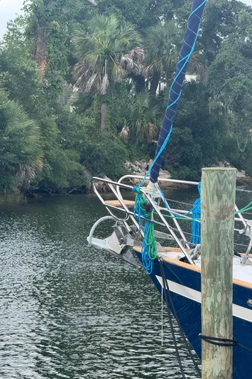 Windsong Yacht Photos Pics Sailboat docked by lush greenery, Taswell 49, 1989 model.