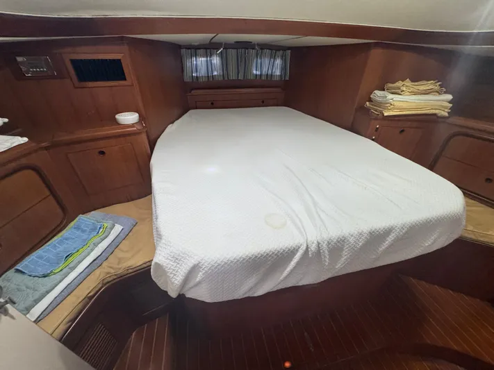Windsong Yacht Photos Pics Cozy cabin interior of 1989 Taswell 49 yacht with neatly arranged bedding.