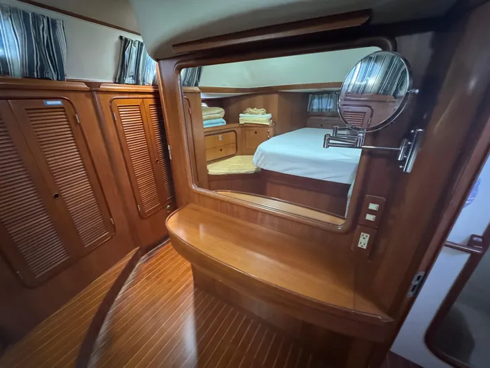 Windsong Yacht Photos Pics Luxurious 1989 Taswell 49 yacht interior with wooden cabinetry and cozy bedroom.