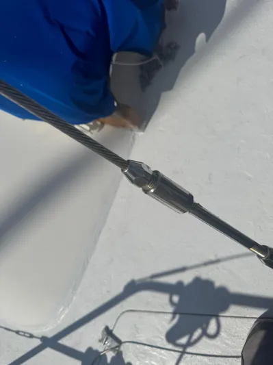 Windsong Yacht Photos Pics Close-up of a Taswell 49 sailboat rigging component, 1989 model, with a person in blue.