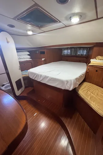 Windsong Yacht Photos Pics Cozy cabin interior of 1989 Taswell 49 yacht with wooden furnishings and comfortable bedding.