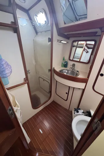 Windsong Yacht Photos Pics Bathroom interior of 1989 Taswell 49 yacht with shower, sink, and toilet.