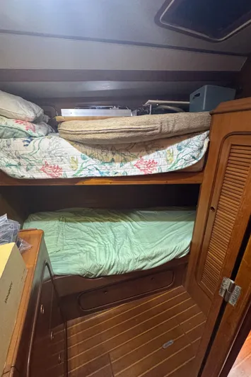Windsong Yacht Photos Pics Cozy cabin interior of 1989 Taswell 49 sailboat with bunk beds and wooden furnishings.