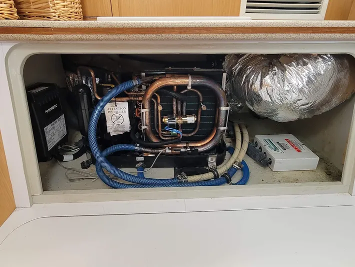 Storyteller Yacht Photos Pics Engine compartment of a 2007 Manta 42 Mk IV sailing catamaran, featuring complex piping and wiring.