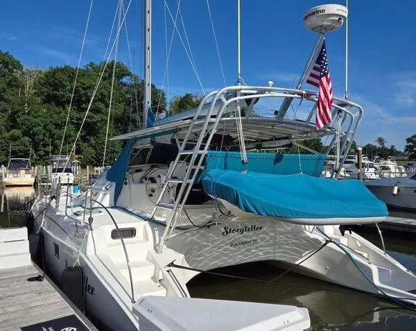 Storyteller Yacht Photos Pics 2007 Manta 42 Mk IV sailing catamaran docked, featuring blue canopy and American flag.