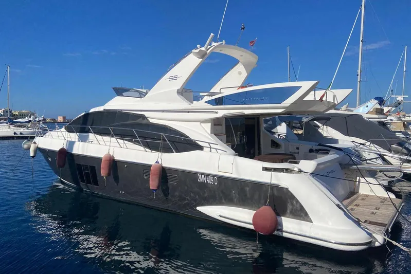  Yacht Photos Pics Luxury 2011 Azimut 58 yacht docked in marina under clear blue sky.