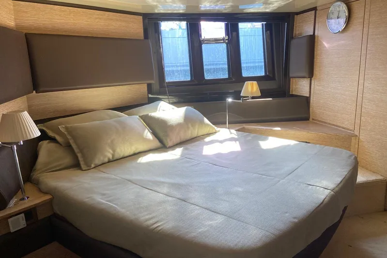  Yacht Photos Pics Luxurious bedroom interior of 2011 Azimut 58 yacht with elegant bedding and natural light.