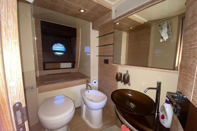  Yacht Photos Pics Luxurious bathroom in 2011 Azimut 58 yacht with modern fixtures and porthole window.