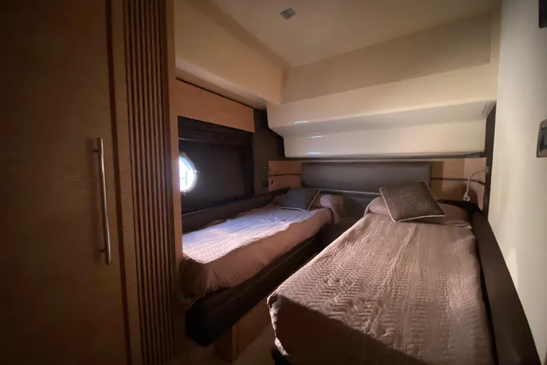  Yacht Photos Pics Interior of 2011 Azimut 58 yacht cabin with twin beds and modern design.