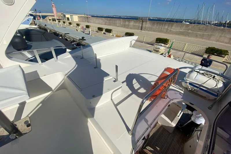  Yacht Photos Pics 2011 Azimut 58 yacht deck with seating, life preserver, and marina view.