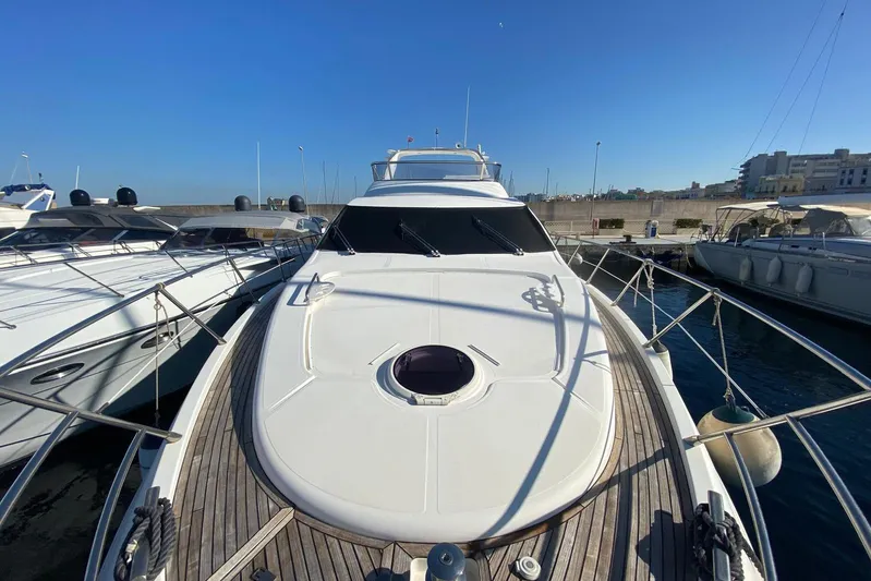  Yacht Photos Pics Luxury 2011 Azimut 58 yacht docked at marina under clear blue sky.