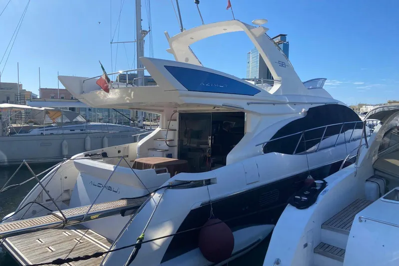  Yacht Photos Pics Luxury 2011 Azimut 58 yacht docked at marina under clear blue sky.