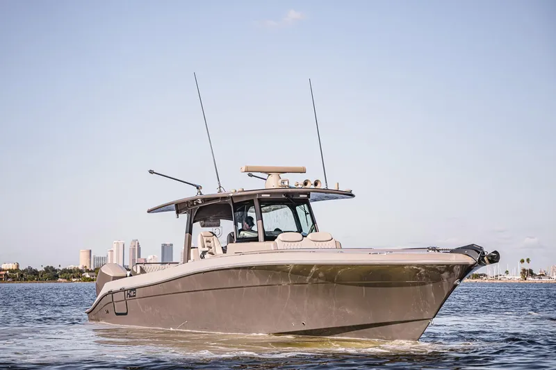 Fifty Shades Of Graydon Yacht Photos Pics 2023 HCB 42 Lujo boat cruising on water with city skyline in background.