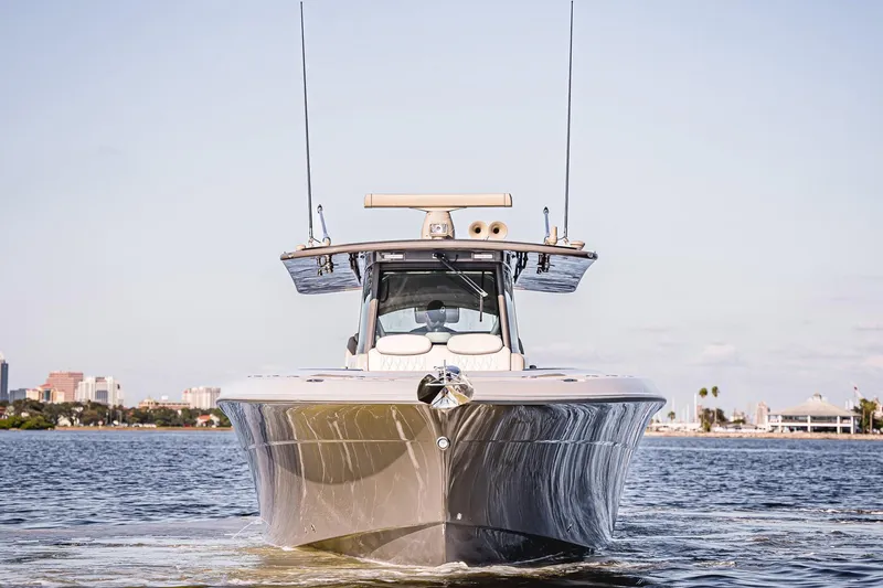 Fifty Shades Of Graydon Yacht Photos Pics 2023 HCB 42 Lujo boat on water, city skyline in background.