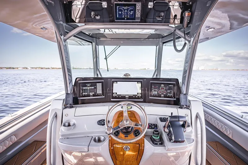 Fifty Shades Of Graydon Yacht Photos Pics Helm of 2023 HCB 42 Lujo boat with advanced navigation systems and luxurious design.