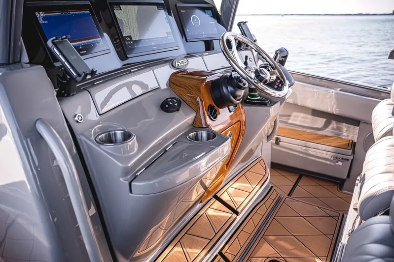 Fifty Shades Of Graydon Yacht Photos Pics Luxurious 2023 HCB 42 Lujo boat helm with modern navigation displays and elegant wood accents.