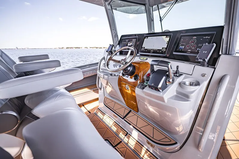 Fifty Shades Of Graydon Yacht Photos Pics Luxurious helm of 2023 HCB 42 Lujo boat with advanced navigation displays.