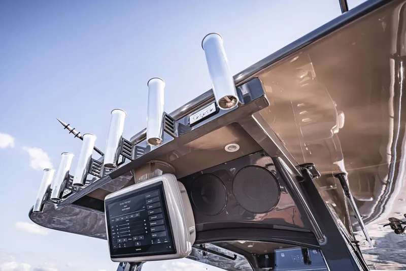 Fifty Shades Of Graydon Yacht Photos Pics 2023 HCB 42 Lujo boat with advanced navigation system and rod holders under clear sky.