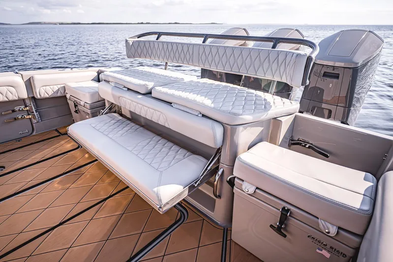 Fifty Shades Of Graydon Yacht Photos Pics Luxurious seating on 2023 HCB 42 Lujo boat with quilted upholstery and ocean backdrop.