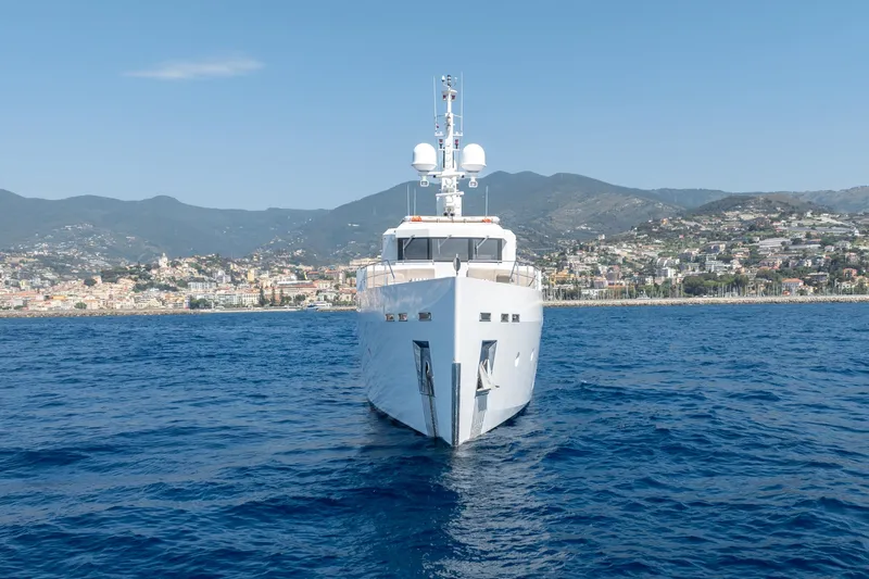 Preference 19 Yacht Photos Pics Luxury Tansu Custom yacht from 2011 on blue sea with coastal city backdrop.