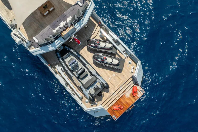 Preference 19 Yacht Photos Pics Aerial view of 2011 Tansu Custom yacht deck with jet skis and tender on blue ocean.