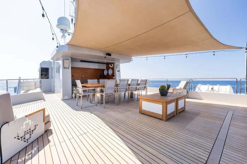 Preference 19 Yacht Photos Pics Luxurious Tansu Custom 2011 yacht deck with dining area, sunshade, and ocean view.