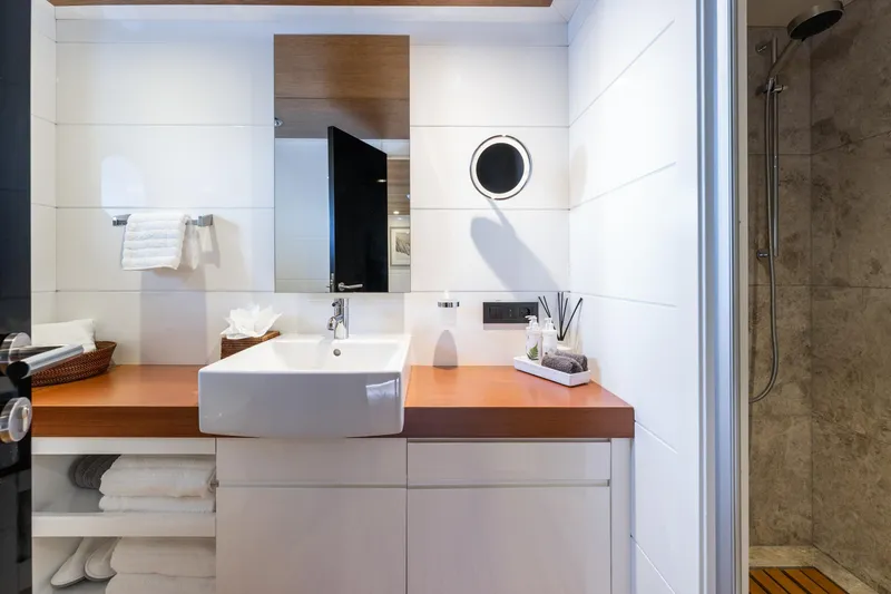 Preference 19 Yacht Photos Pics Modern bathroom with white sink, wooden countertop, and shower in a 2011 Tansu Custom yacht.