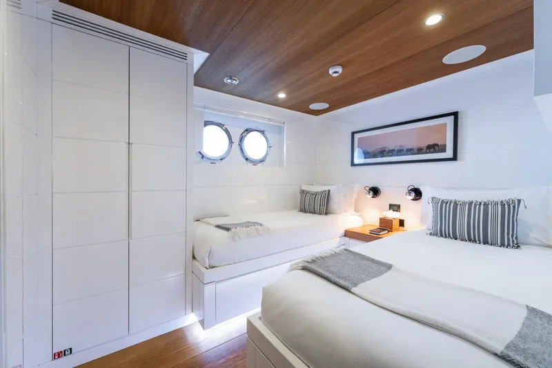 Preference 19 Yacht Photos Pics Luxurious Tansu Custom 2011 yacht cabin with twin beds, wooden ceiling, and porthole windows.