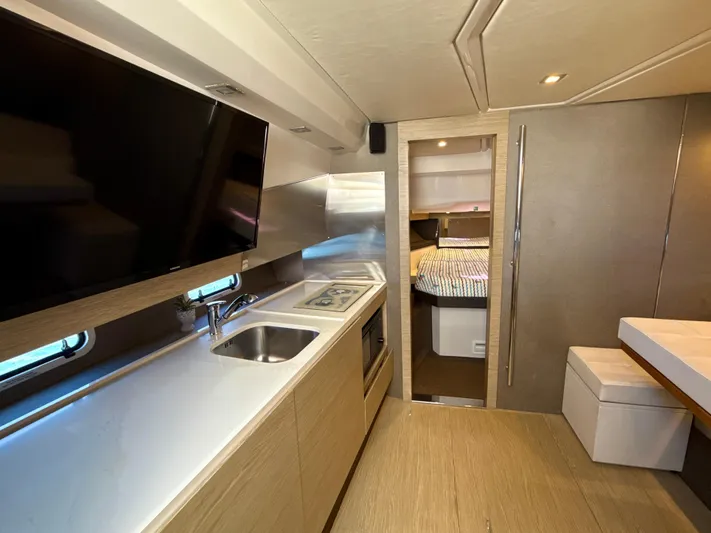 Le Kiki Yacht Photos Pics Interior of 2019 Azimut 40 Verve yacht with modern kitchen and cozy bedroom.