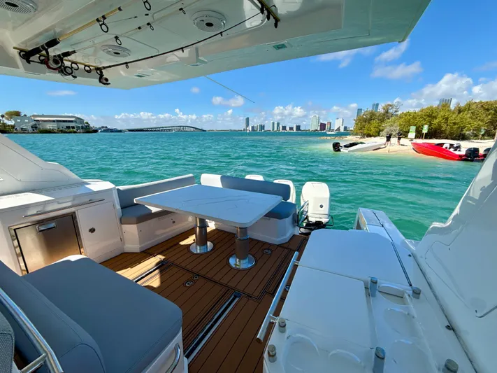 Le Kiki Yacht Photos Pics Azimut 40 Verve 2019 yacht with elegant deck, overlooking turquoise waters and city skyline.