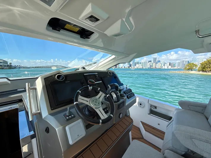 Le Kiki Yacht Photos Pics 2019 Azimut 40 Verve yacht helm with city skyline and ocean view.