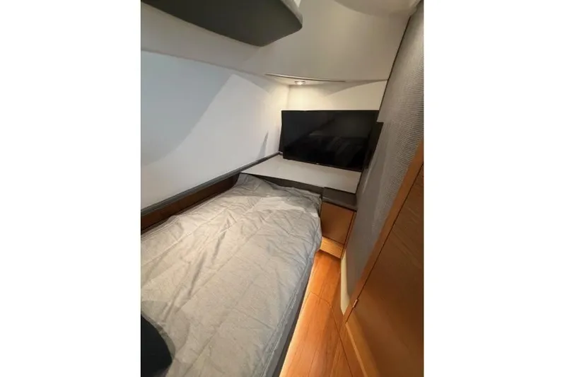  Yacht Photos Pics 2021 Tiara Sport 38 LS cabin interior with bed and TV, featuring modern design.