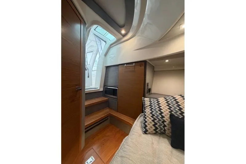  Yacht Photos Pics Interior of 2021 Tiara Sport 38 LS yacht, featuring modern wood finishes and cozy seating.