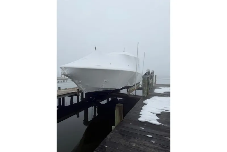  Yacht Photos Pics 2021 Tiara Sport 38 LS boat covered in snow on a dock.