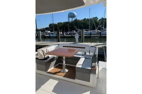  Yacht Photos Pics 2021 Tiara Sport 38 LS yacht with elegant seating and table, docked at a marina.