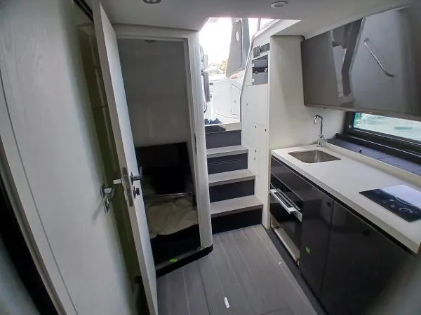 No Name Yacht Photos Pics 2024 Azimut Verve 42 interior with modern kitchen and stairs to deck.
