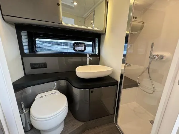 No Name Yacht Photos Pics Luxurious bathroom in 2024 Azimut Verve 42 yacht with modern fixtures and shower.